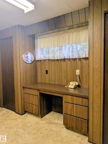 Built-in desk with five drawers and a dark countertop - 6014 50 Street, Vegreville, AB - Indoor Photo Showing Other Room