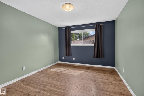 Wood-finish flooring, white trim, single window, and flush mount ceiling light - 2011 151 Avenue Nw, Edmonton, AB - Indoor Photo Showing Other Room