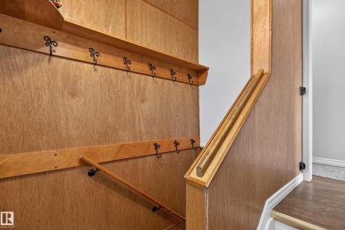 Wood-finish paneling with integrated shelving and coat hooks - 2011 151 Avenue Nw, Edmonton, AB - Indoor Photo Showing Other Room