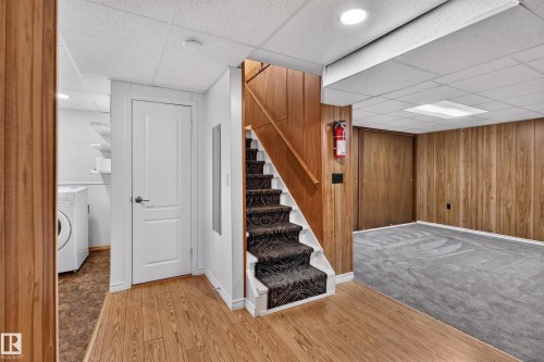 Wood-finish flooring, paneled walls, and built-in laundry appliances - 2011 151 Avenue Nw, Edmonton, AB - Indoor