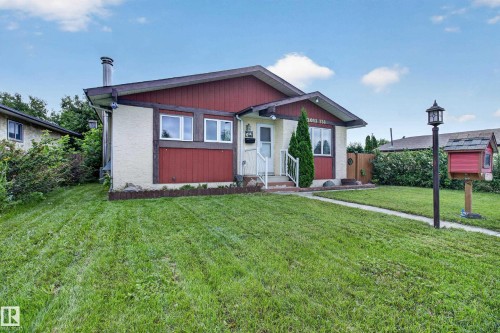 Ranch-style exterior with stucco and wood paneling, white window frames, and a prominent front entrance - 2011 151 Avenue Nw, Edmonton, AB - Outdoor