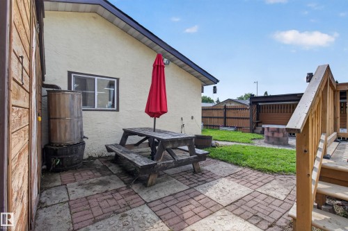 Paved patio area featuring checkerboard-patterned pavers - 2011 151 Avenue Nw, Edmonton, AB - Outdoor With Exterior