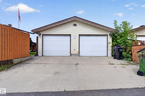 Two-car garage with overhead doors and concrete driveway - 2011 151 Avenue Nw, Edmonton, AB - Outdoor With Exterior