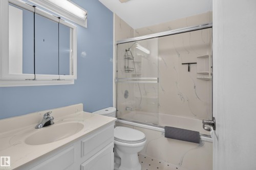 Vanity with integrated sink, chrome-finish faucet, and coordinating countertop - 2011 151 Avenue Nw, Edmonton, AB - Indoor Photo Showing Bathroom