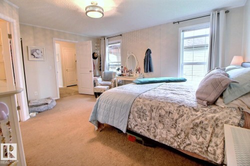 Recessed lighting fixture, light-colored carpeting, multiple windows with blinds, white paneled walls, and white interior doors - 417 Oak Wood Crescent Northwest, Edmonton, AB - Indoor Photo Showing Bedroom