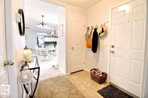 Entryway featuring a paneled door, wood-finish flooring, and light-toned walls - 417 Oak Wood Crescent Northwest, Edmonton, AB - Indoor Photo Showing Other Room