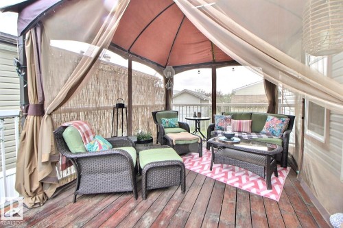 Outdoor gazebo with a fabric canopy, wood-finish decking, and integrated privacy screens - 417 Oak Wood Crescent Northwest, Edmonton, AB - Outdoor With Deck Patio Veranda With Exterior