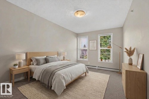 Recessed lighting, light gray wall finishes, dual windows, and carpeted flooring - #205 6315 135 Av Nw, Edmonton, AB - Indoor Photo Showing Bedroom