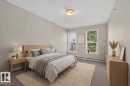 Recessed lighting, light gray wall finishes, dual windows, and carpeted flooring - #205 6315 135 Av Nw, Edmonton, AB  - Indoor Photo Showing Bedroom 