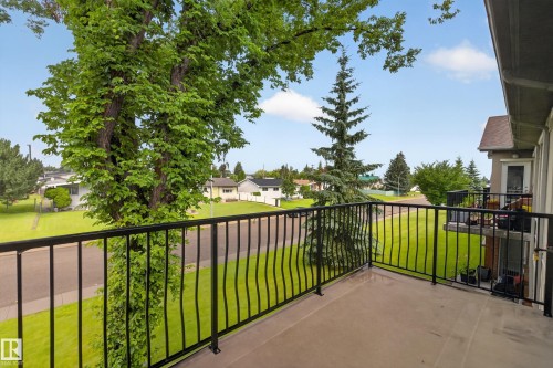 Balcony featuring metal railings and a concrete surface - #205 6315 135 Av Nw, Edmonton, AB - Outdoor With Balcony