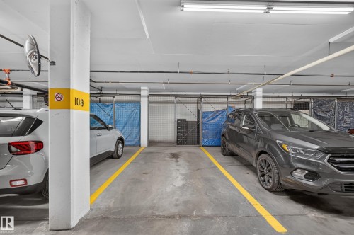 Designated parking space with overhead lighting - #205 6315 135 Av Nw, Edmonton, AB - Indoor Photo Showing Garage