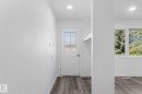 White interior door with decorative glass inserts, recessed lighting, wood-finish flooring, and white trim - 7823 136 Avenue Nw, Edmonton, AB  - Indoor Photo Showing Other Room 