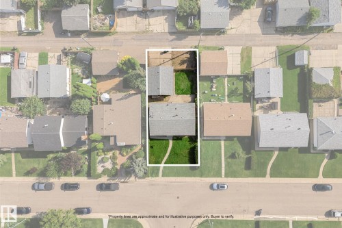 Street-facing property with a manicured lawn, two detached structures, and a partial concrete driveway - 7823 136 Avenue Nw, Edmonton, AB - Other