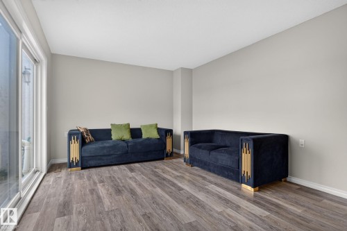 Wood-finish flooring, light neutral wall paint, and sliding glass patio doors - 17775 95 Street Nw, Edmonton, AB 
