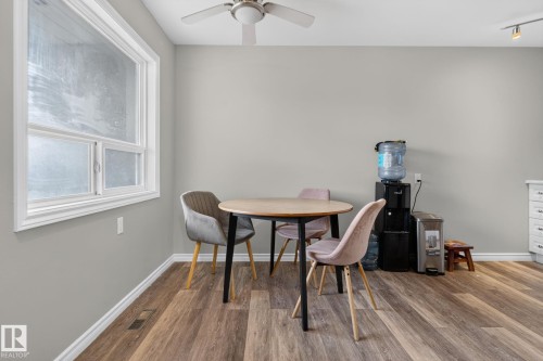 Wood-finish flooring, white trim, and a ceiling fan with integrated lighting - 17775 95 Street Nw, Edmonton, AB 