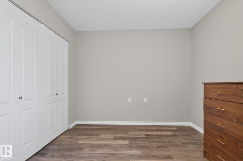 Wood-finish flooring with neutral wall paint and white trim - 17775 95 Street Nw, Edmonton, AB 
