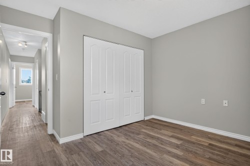 Wood-finish flooring, light gray wall paint, and white trim accents - 17775 95 Street Nw, Edmonton, AB 