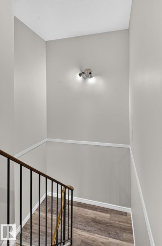 Wood-finish flooring, white wall trim, and light gray wall paint - 17775 95 Street Nw, Edmonton, AB 