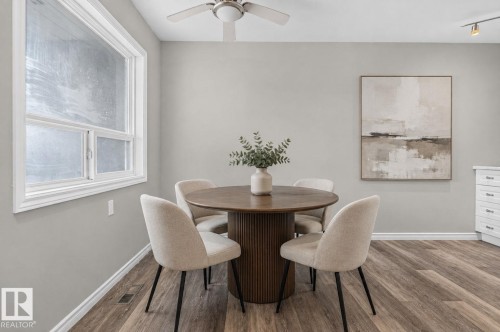 Wood-finish flooring, white trim, a ceiling fan with light, and track lighting fixtures - 17775 95 Street Nw, Edmonton, AB 