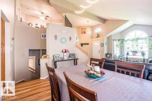 Vaulted ceiling with an arched window, wood-finish flooring, and a multi-level layout - 4705 43 Street, Beaumont, AB 