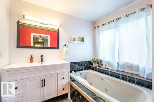 White vanity with integrated sink and matte black hardware - 4705 43 Street, Beaumont, AB 