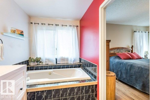 Built-in soaking tub with black and white patterned tile surround - 4705 43 Street, Beaumont, AB 