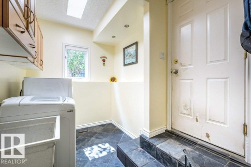 Recessed lighting, wood-finish cabinetry, a skylight, a window, and slate tile flooring - 4705 43 Street, Beaumont, AB 