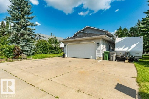 Attached two-car garage with a white overhead door - 4705 43 Street, Beaumont, AB 