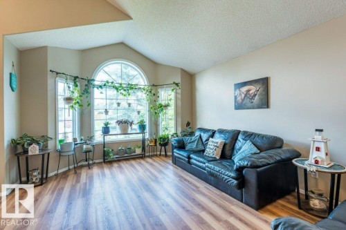 Vaulted ceiling with an arched window and wood-finish flooring - 4705 43 Street, Beaumont, AB 