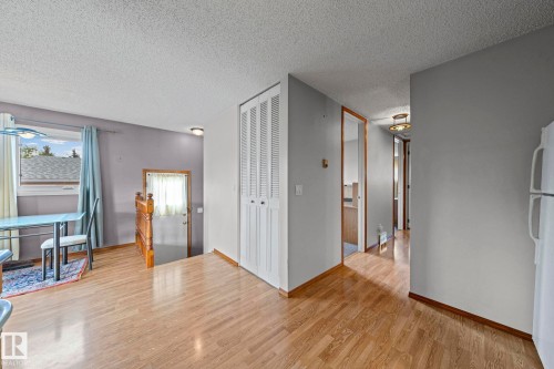 Wood-finish flooring throughout, complemented by light gray wall paint - 17908 92A Street Nw, Edmonton, AB - Indoor Photo Showing Other Room