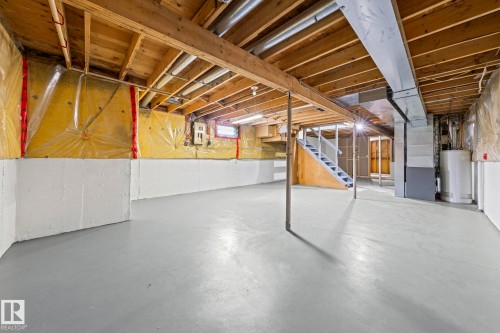 Unfinished basement with exposed wood joists and concrete flooring - 17908 92A Street Nw, Edmonton, AB - Indoor Photo Showing Basement