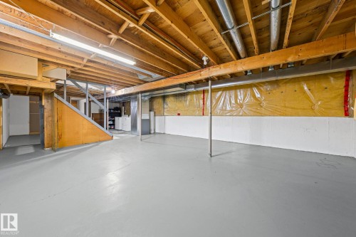Open unfinished basement with exposed wood joists, concrete flooring, and partial wall insulation - 17908 92A Street Nw, Edmonton, AB - Indoor Photo Showing Basement