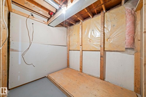 Unfinished room with exposed wood framing, partial drywall installation, visible insulation, and exposed ceiling joists - 17908 92A Street Nw, Edmonton, AB - Indoor Photo Showing Basement