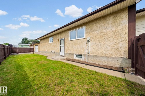 Exterior stucco finish, fenced yard, concrete walkway, and white-framed windows - 17908 92A Street Nw, Edmonton, AB - Outdoor With Exterior