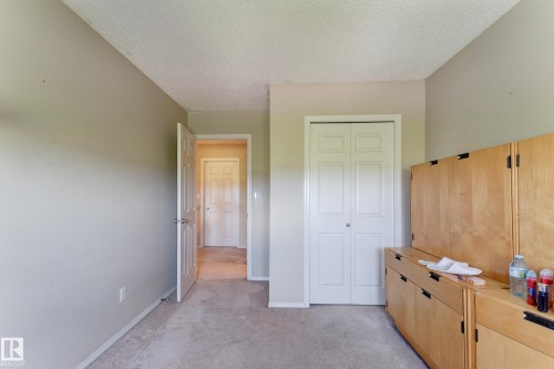 Neutral wall tones, textured ceiling, and carpeted flooring - 6218 1A Avenue Sw, Edmonton, AB - Indoor