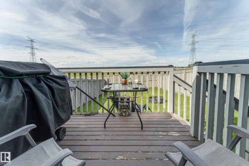 Wood-finish deck with a painted wooden railing and a fenced yard beyond - 6218 1A Avenue Sw, Edmonton, AB - Outdoor With Deck Patio Veranda With Exterior