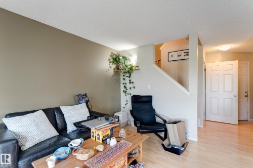 Light wood-finish flooring, two-panel interior doors, and a built-in staircase - 6218 1A Avenue Sw, Edmonton, AB - Indoor