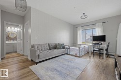 Wood-finish flooring throughout, light-colored walls, and a window with horizontal blinds - 