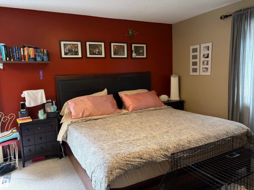 Accent wall featuring a rich reddish-brown finish - 10994 126 St Nw Nw, Edmonton, AB - Indoor Photo Showing Bedroom
