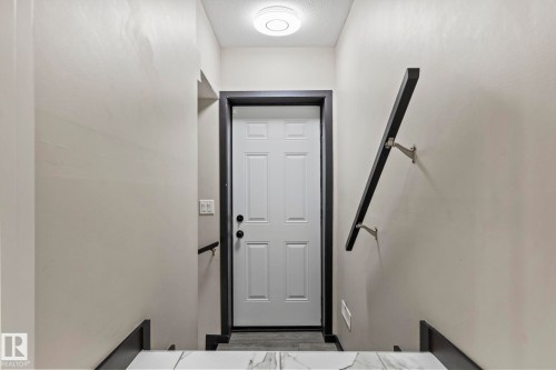 White paneled door with dark trim - 5210 23 Ave Sw, Edmonton, AB - Indoor Photo Showing Other Room