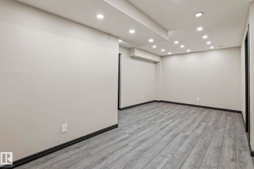 Recessed lighting, wood-finish flooring, light neutral wall paint, dark trim - 5210 23 Ave Sw, Edmonton, AB - Indoor