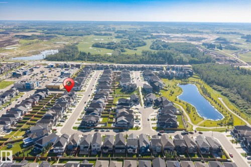 Residential neighborhood featuring a street grid, uniform housing styles, and a central water feature - 5210 23 Ave Sw, Edmonton, AB - Outdoor With View