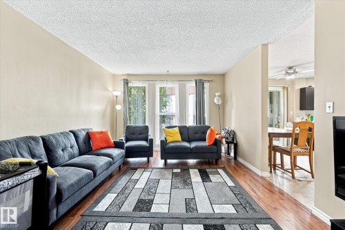 Expansive living area featuring wood-finish flooring, neutral wall tones, and recessed window openings - 6471 180 Street Nw, Edmonton, AB - Indoor Photo Showing Living Room