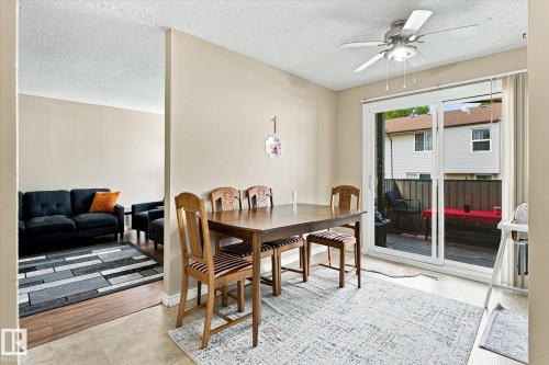Sliding glass door access to an outdoor deck, recessed lighting, and a ceiling fan with integrated lighting - 6471 180 Street Nw, Edmonton, AB - Indoor Photo Showing Dining Room