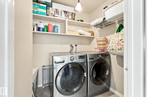 Laundry area featuring built-in shelving, wire shelving, and a ceiling-mounted light fixture - 6471 180 Street Nw, Edmonton, AB - Indoor Photo Showing Laundry Room