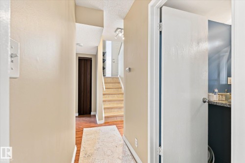 Hallway featuring wood-finish flooring, staircase with wood-finish treads, and recessed lighting - 6471 180 Street Nw, Edmonton, AB - Indoor Photo Showing Other Room