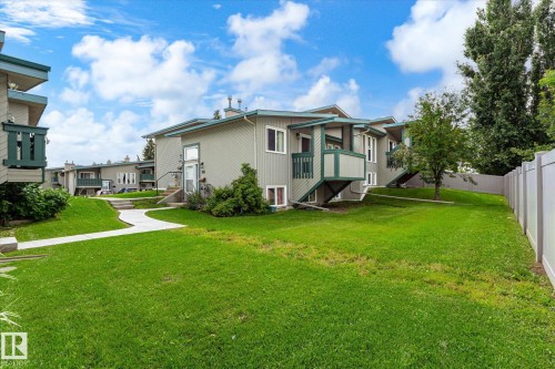 Multiple residential buildings with light gray siding and dark green trim - 6471 180 Street Nw, Edmonton, AB - Outdoor