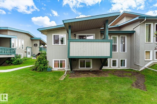 Multi-level residential structure with vertical siding and multiple window configurations - 6471 180 Street Nw, Edmonton, AB - Outdoor