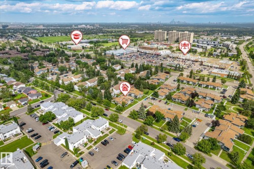 Aerial perspective highlighting a residential neighborhood with ample green spaces and a commercial area - 6471 180 Street Nw, Edmonton, AB - Outdoor With View