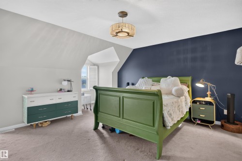 Angled ceiling lines, recessed window with louvered shutters, flush-mount ceiling light, carpeting throughout - 4471 Mccrae Avenue Nw, Edmonton, AB - Indoor Photo Showing Bedroom
